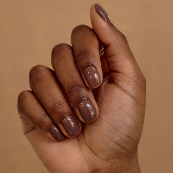 Unhas de cor marrom nude em um estilo de esmaltação nude